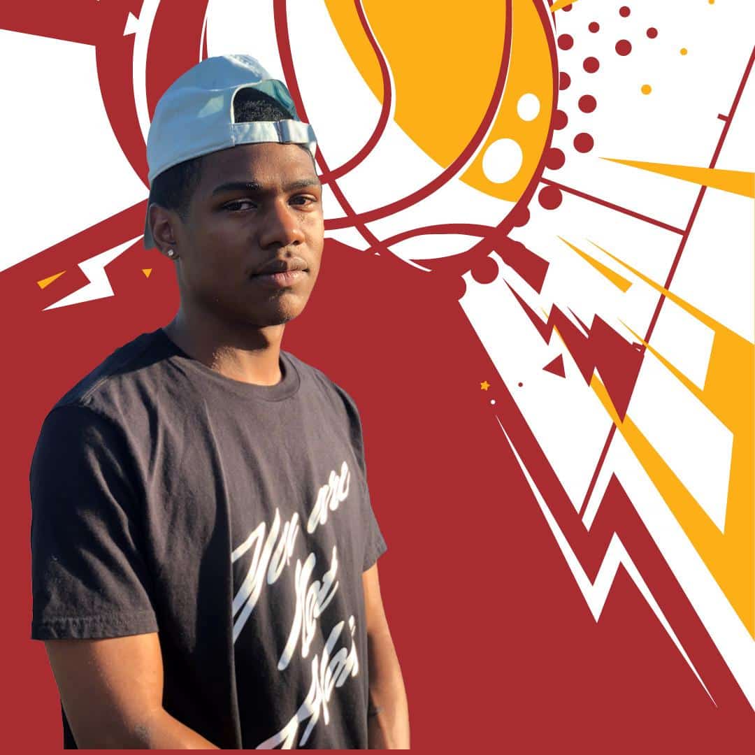 Young man in a dark T-shirt and light-blue cap stands before a bold red–yellow abstract mural, facing the camera.