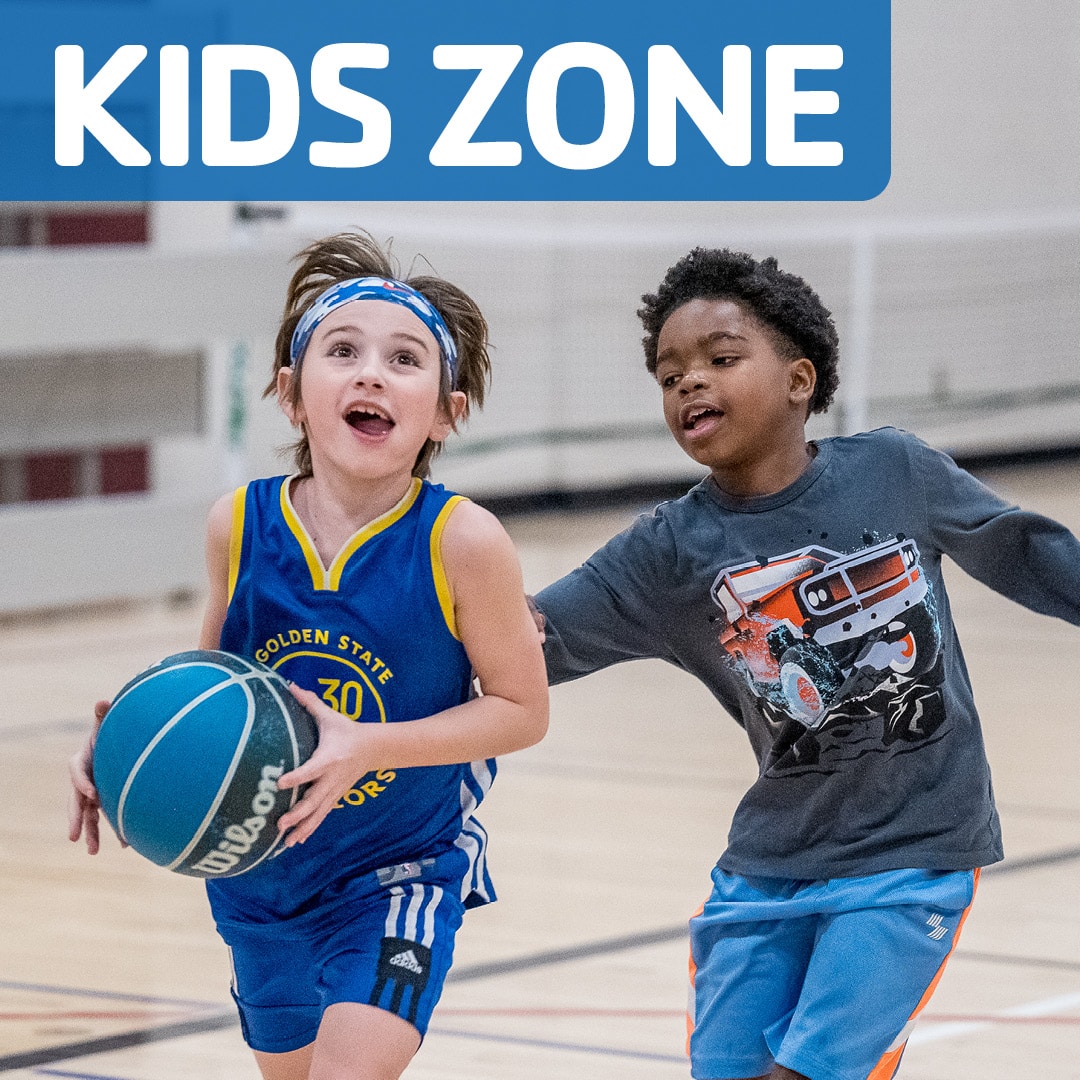 Two kids play basketball in a gym under a bold blue 'KIDS ZONE' banner at the top.
